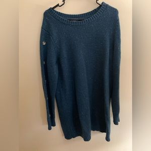 Tunic length sweater with button details down each sleeve.